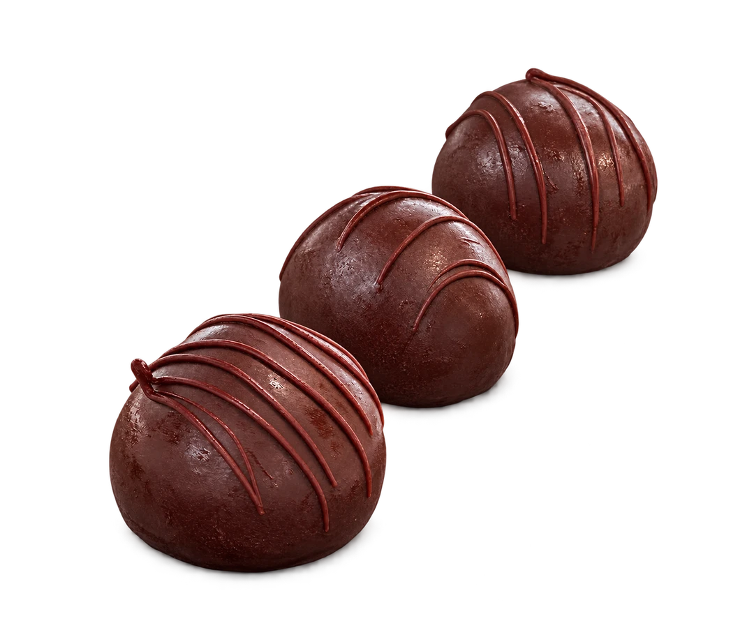 Three small Chocolate Potato pastries in a diagonal row